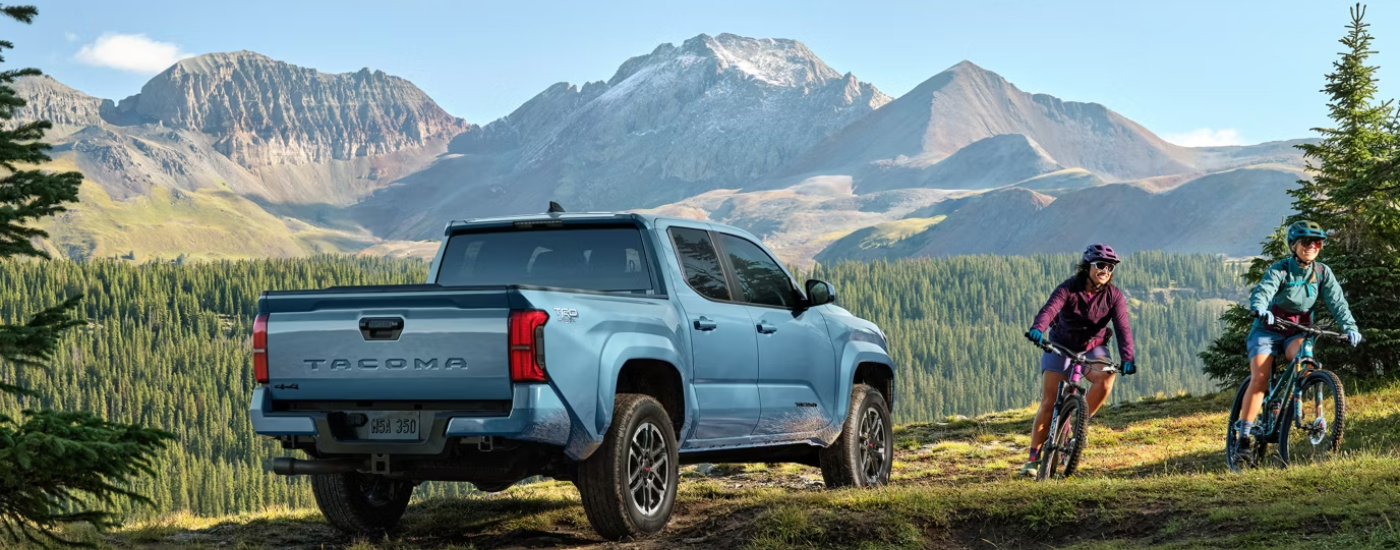 Blue 2026 Toyota Tacoma TRD Off-Road with bikers riding by