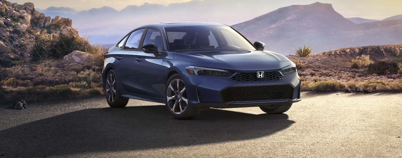 Blue 2026 Honda Civic parked on a pavement.