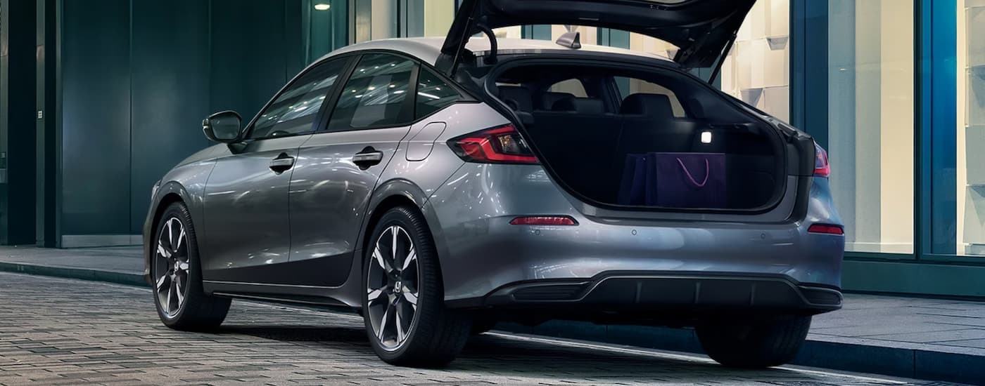 Rear of a grey 2026 Honda Civic with an open hatch.