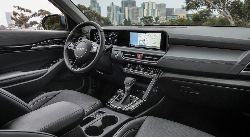 The steering wheel and dashboard in the interior of a 2026 Kia Seltos.