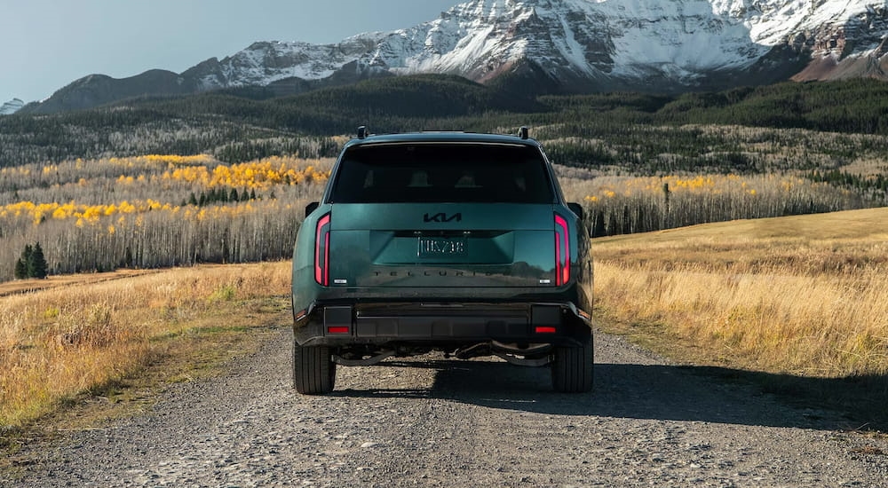 Rear of a green 2027 Kia Telluride parked off-road.