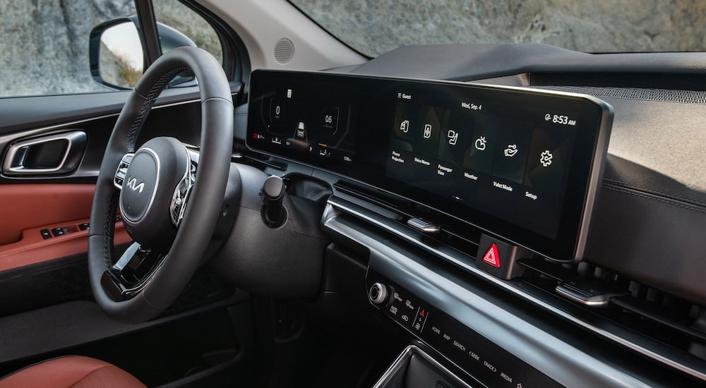 Steering wheel and dashboard inside of a 2026 Kia Carnival.