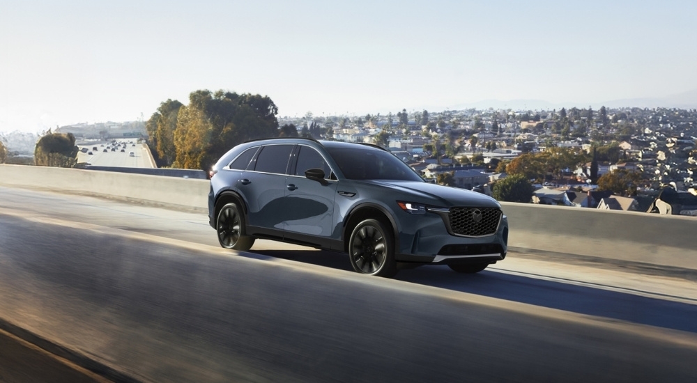 Grey 2026 Mazda CX-90 driving on a higway