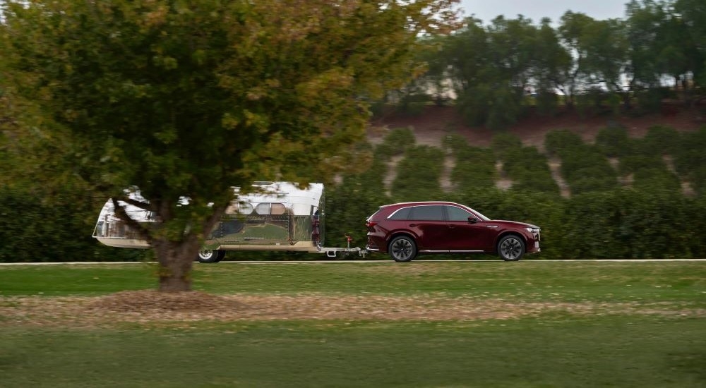 Purple 2026 Mazda CX-90 towing a trailer