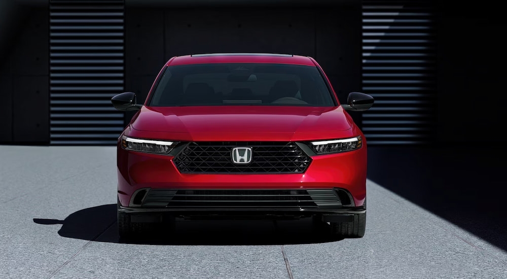 Front of a red 2026 Honda Accord parked near a building.