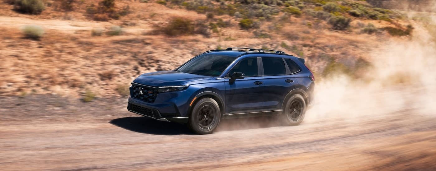 Dark blue 2026 Honda CR-V driving off-road.