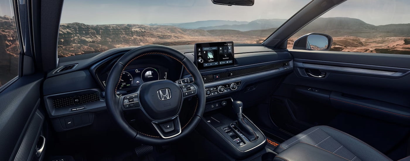 Steering wheel and dashboard in the interior of a 2026 Honda CR-V Hybrid.