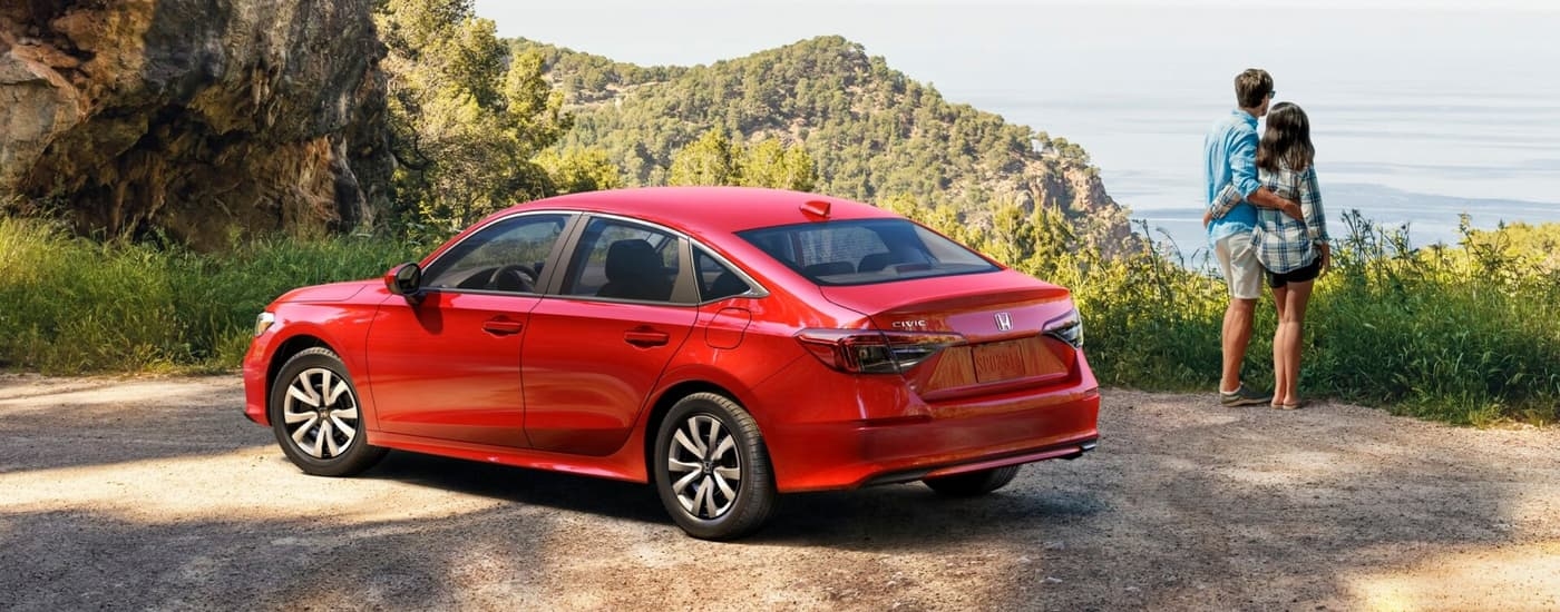 Red 2026 Honda Civic parked near an overlook hiking trail
