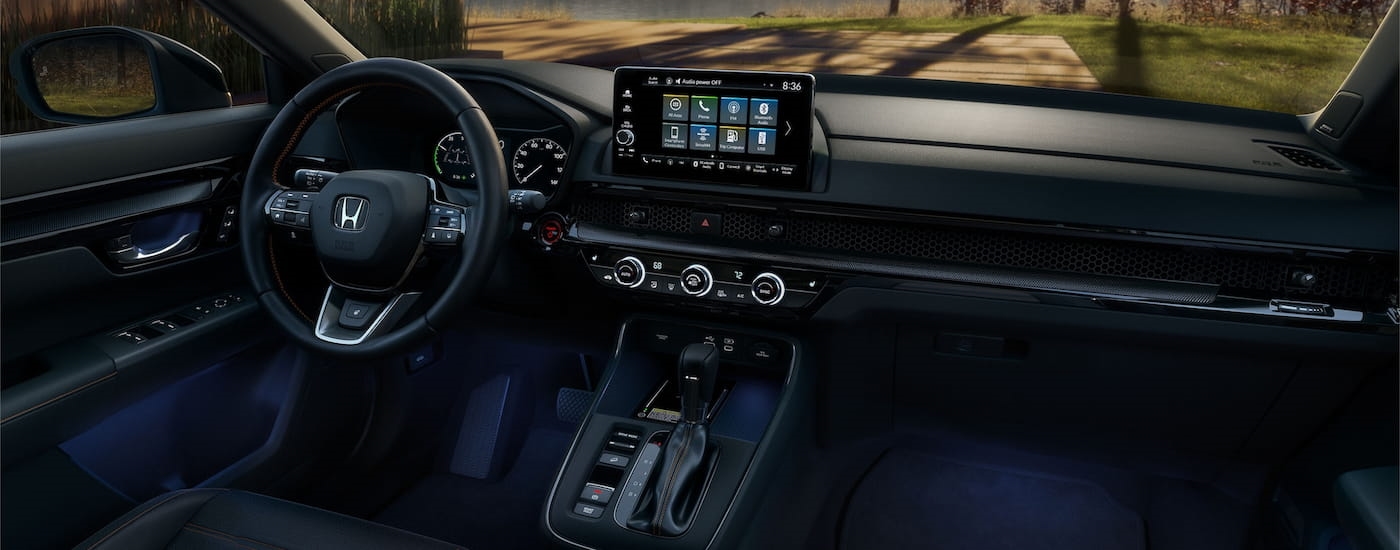 Steering wheel and dashboard in the interior of a 2026 Honda CR-V Hybrid.
