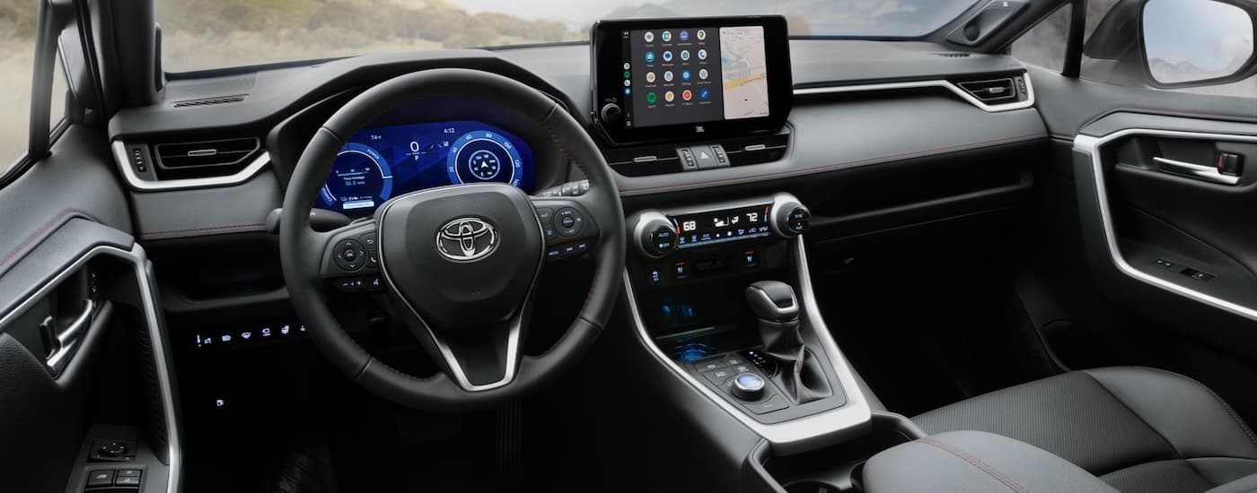 The steering wheel and dashboard in the interior of a 2026 Toyota RAV4.