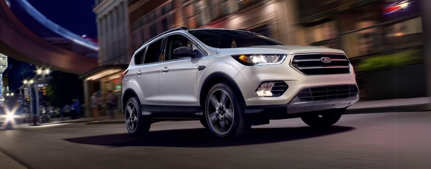 White 2019 Ford Escape driving down a city street.