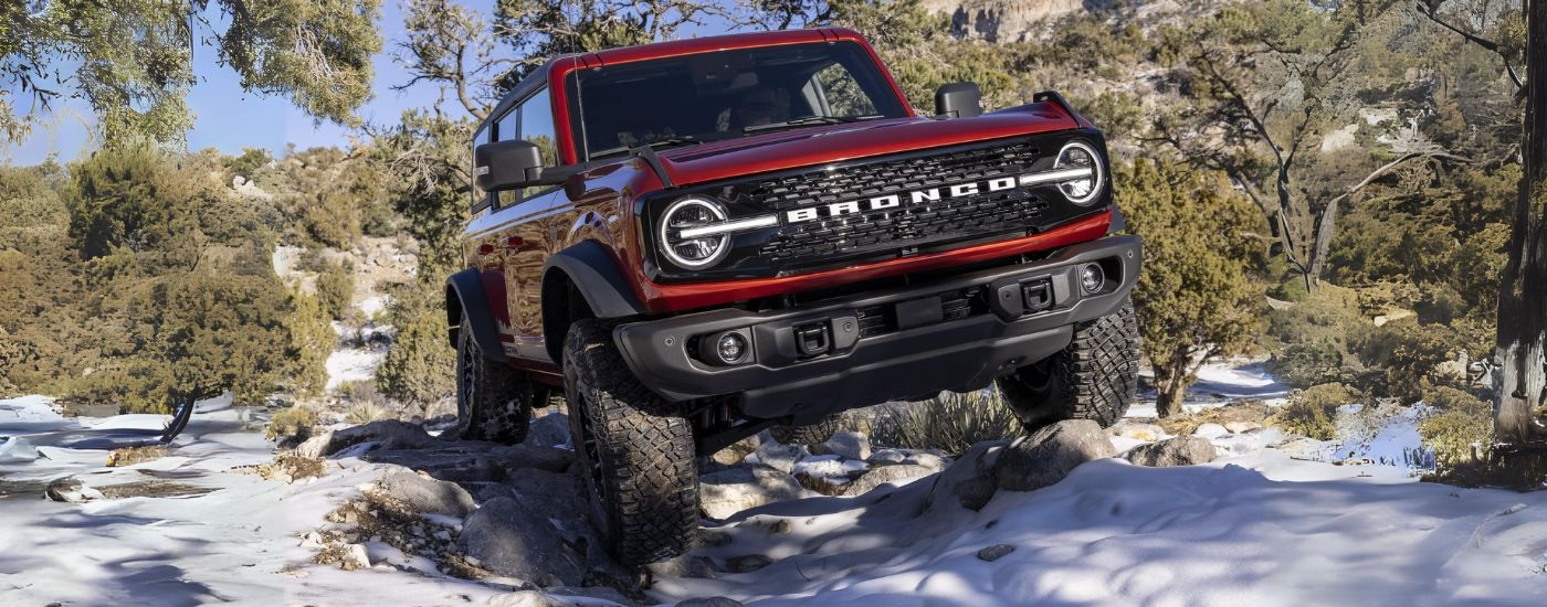 Red 2022 Ford Bronco driving off-road.