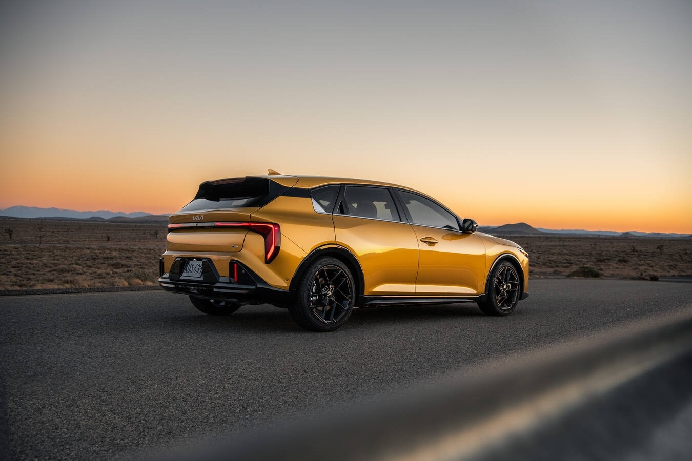 2026 Kia K4 Hatchback side profile in Currant Red showing floating roofline design and 18-inch alloy wheels