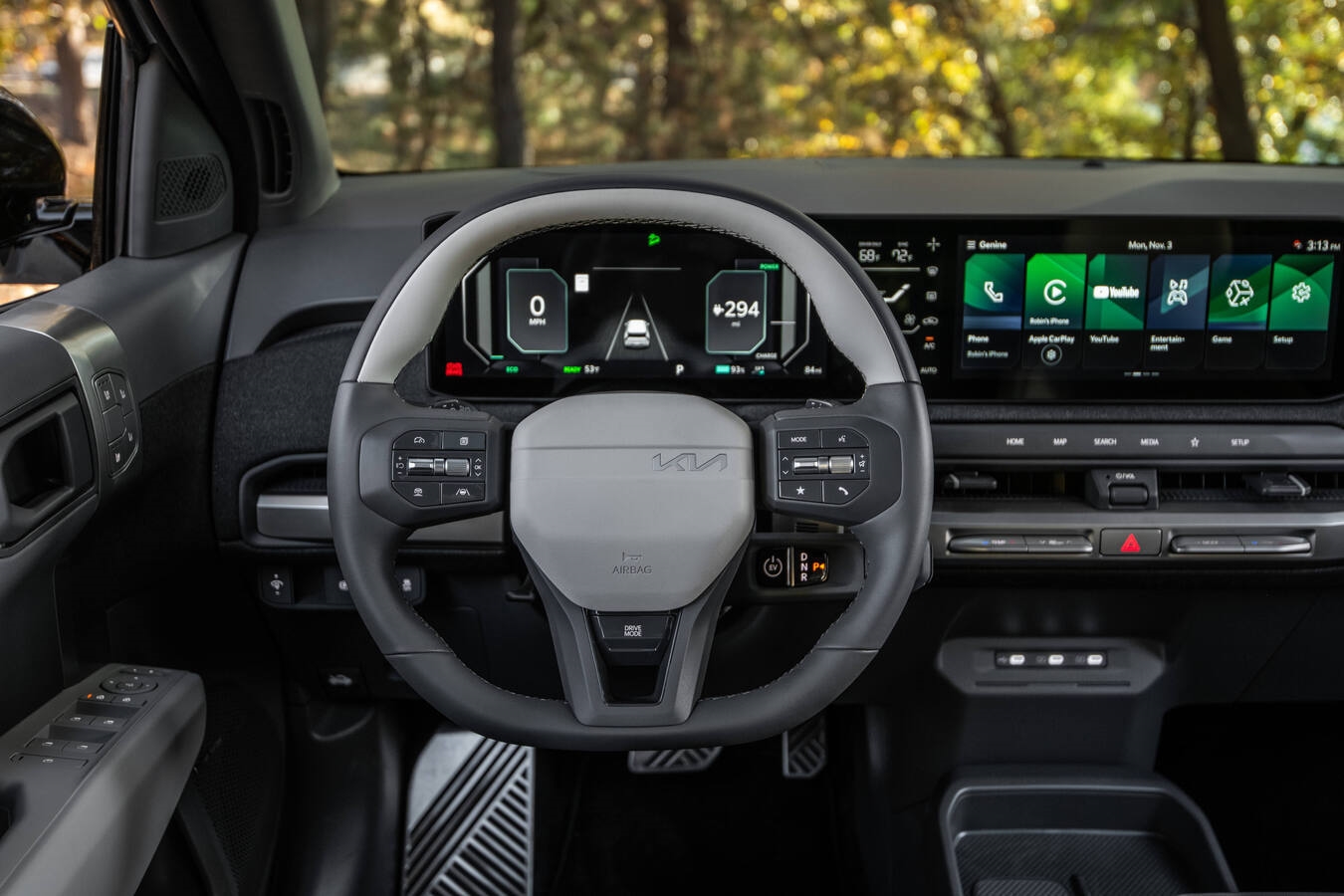 2027 Kia EV3 interior panoramic display with dual 12.3-inch screens, climate panel, and spacious cabin layout