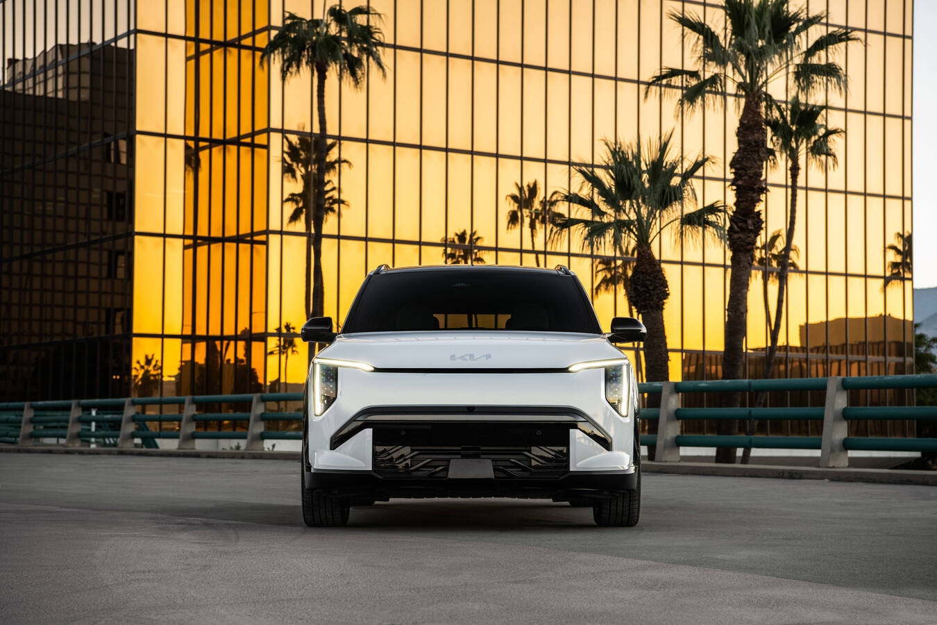 2027 Kia EV3 GT trim rear three-quarter view showing neon green brake calipers, 19-inch wheels, and Star Map LED taillights