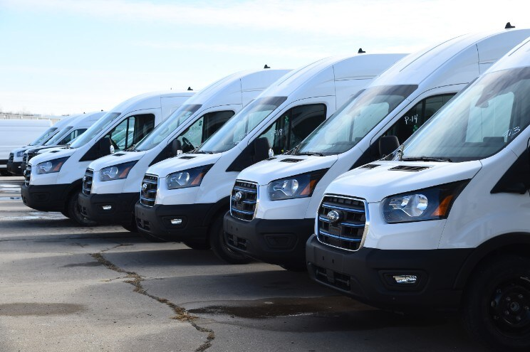 Fleet of Ford Transit vans lined up for commercial vehicle service and business use