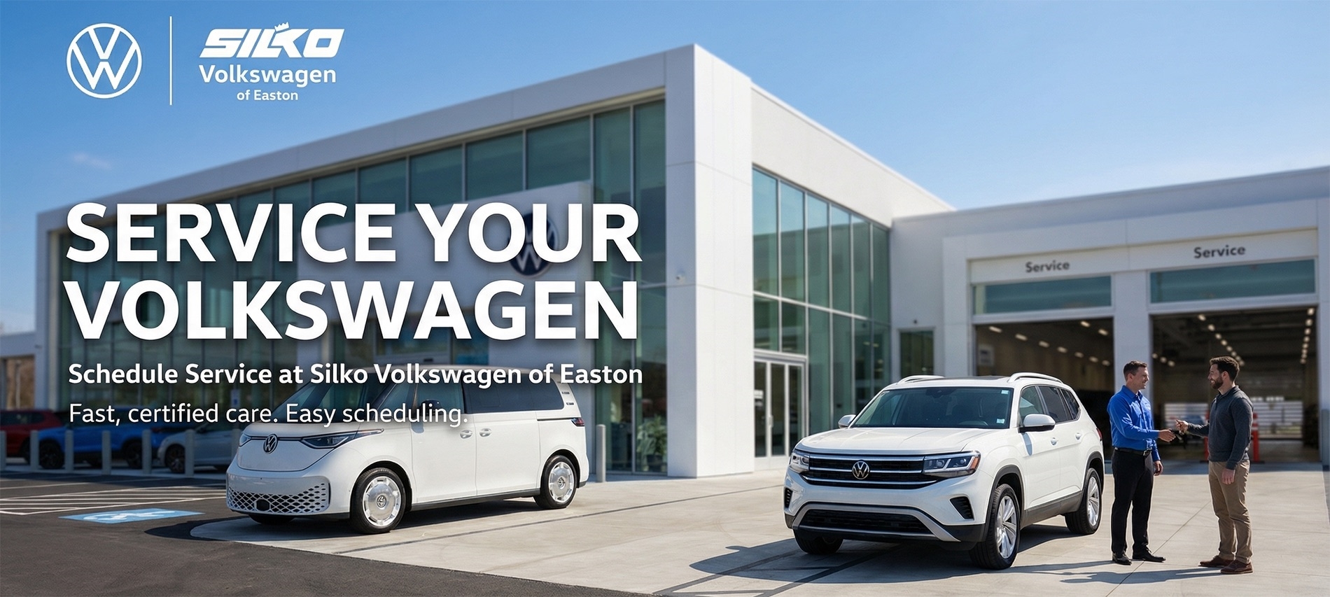 Silko Volkswagen of Easton service center exterior with Volkswagen SUV and ID. Buzz parked outside, customer and service advisor standing near service bays, dealership building with glass facade and “Service” lanes visible, clean bright daytime setting