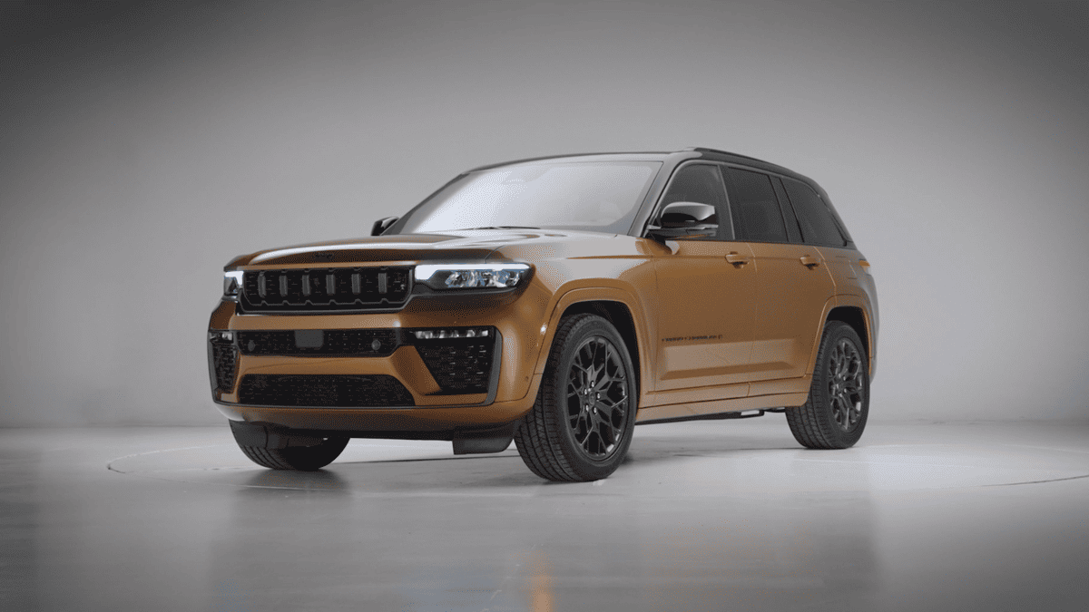 2026 Jeep Grand Cherokee in Margate FL shown in bronze exterior color with black roof, seven-slot grille, LED headlights, and black alloy wheels on studio background