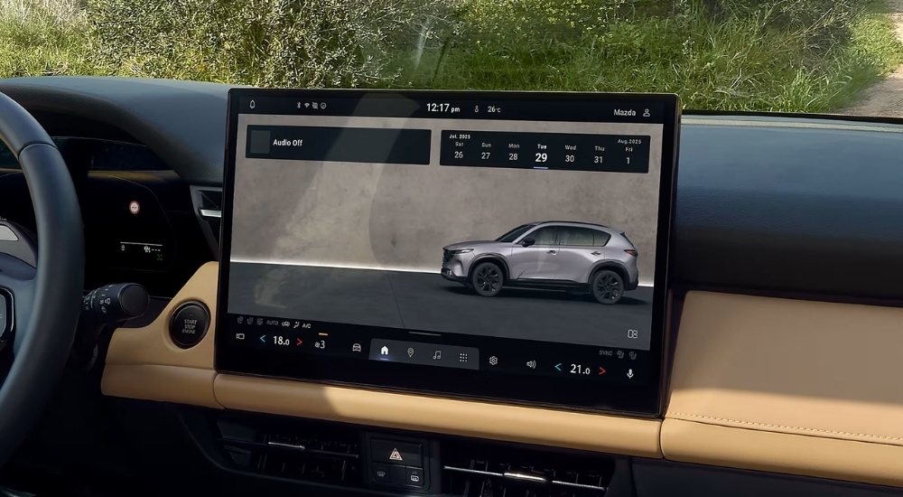 Person using the infotainment screen in a 2026 Mazda CX-5