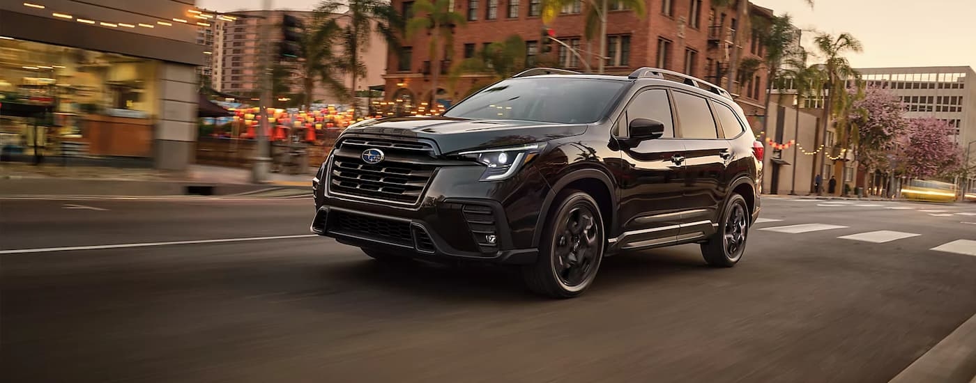 A black 2026 Subaru Ascent driving in a city