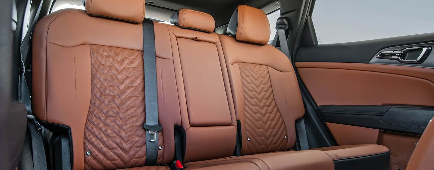 Tan passenger seats in the interior of a 2026 Kia Sportage.