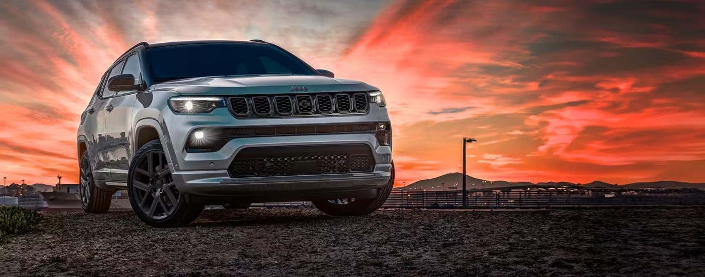 White 2025 Jeep Compass parked off-road.