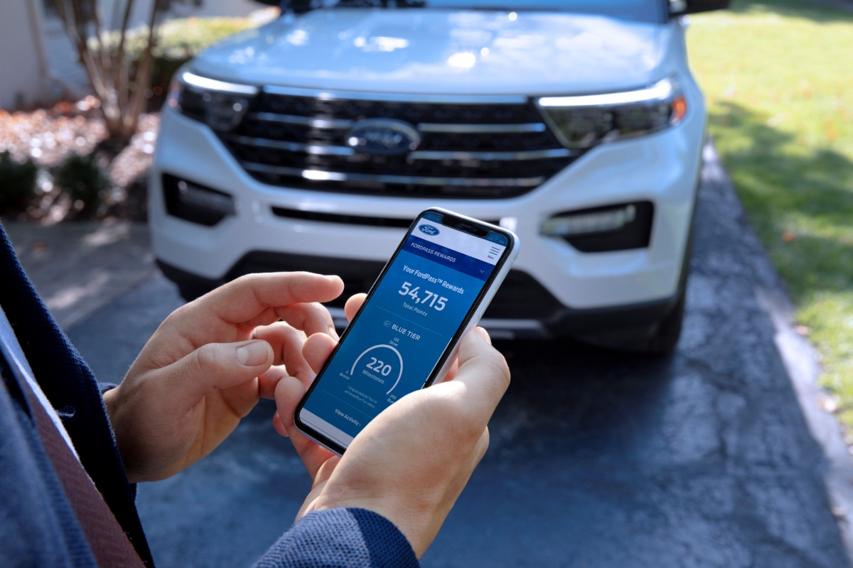 Customer using smartphone to manage vehicle service for pickup and delivery