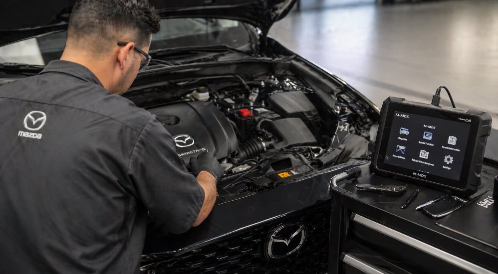 Mazda CX-5 instrument cluster showing the amber check engine light illuminated