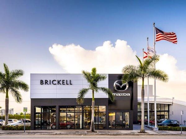 Brickell Mazda dealership exterior with palm trees on SW 8th St in Miami