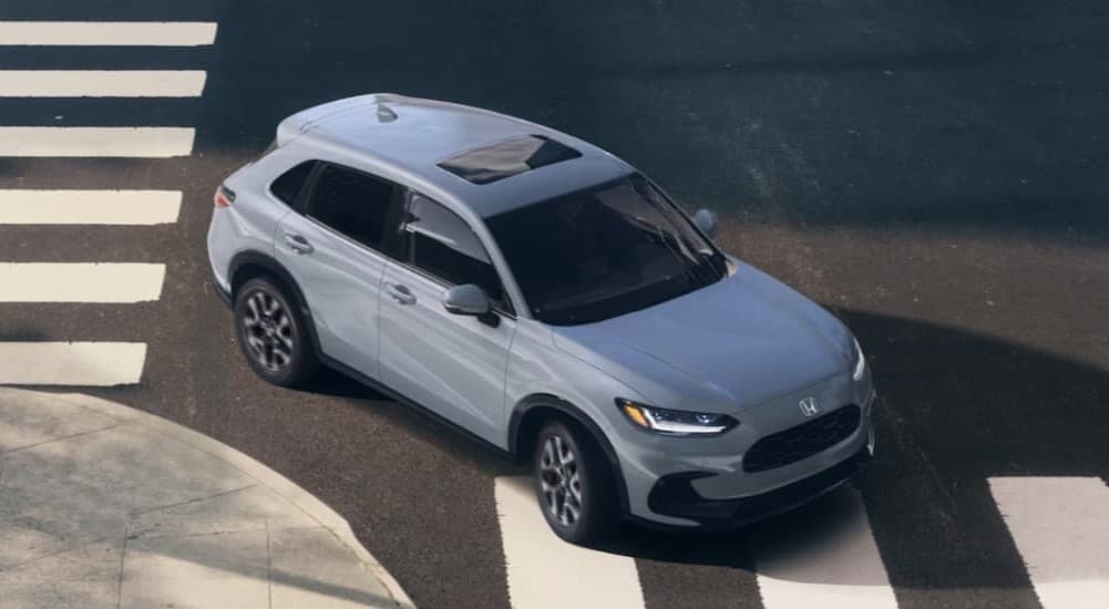 A gray 2026 Honda HR-V driving in a city.