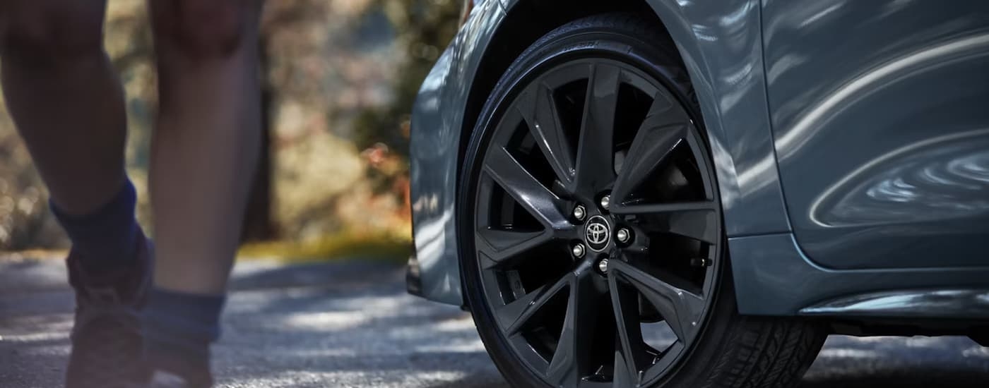 Black rim and tire on a blue 2026 Toyota Corolla