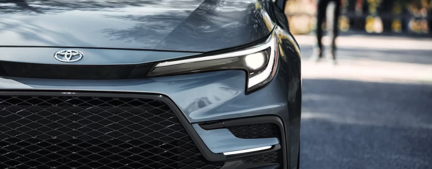 Headlight and grille on a blue 2026 Toyota Corolla