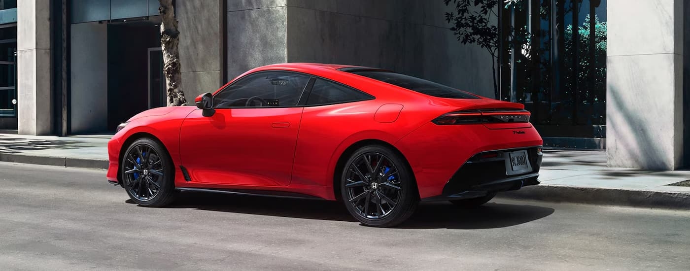 A red 2026 Honda Prelude parked on a city street