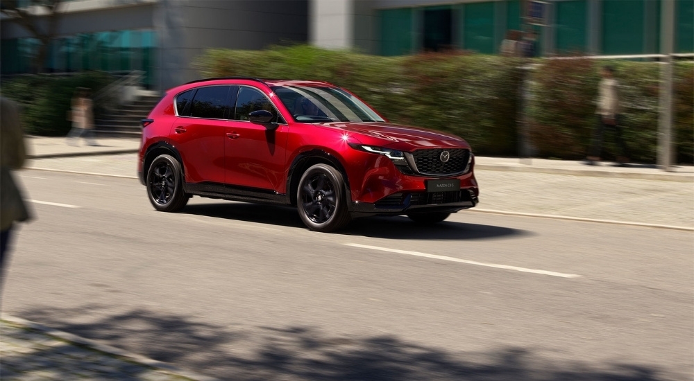 Red 2026 Mazda CX-5 for sale near Katy driving on a city street
