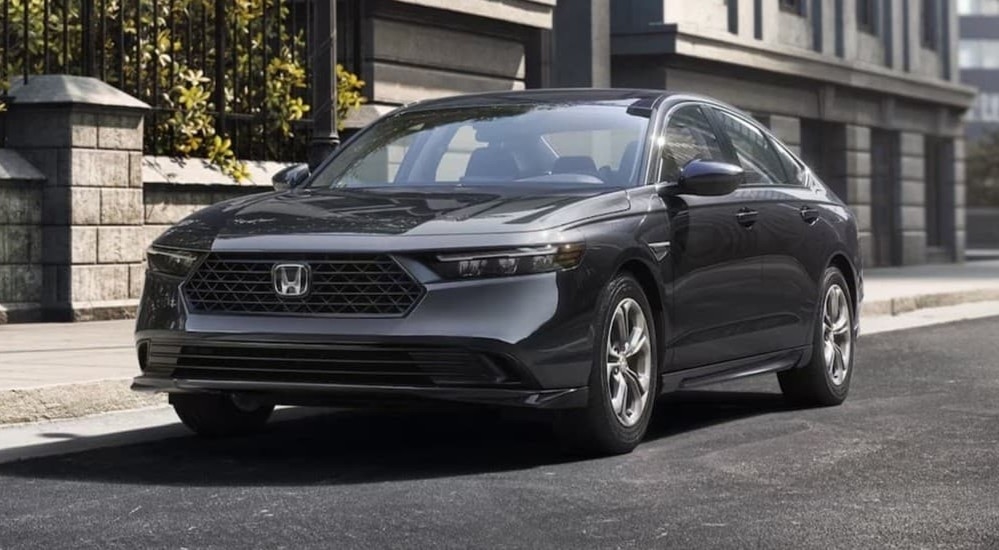 A gray 2026 Honda Accord Hybrid parked in a city.