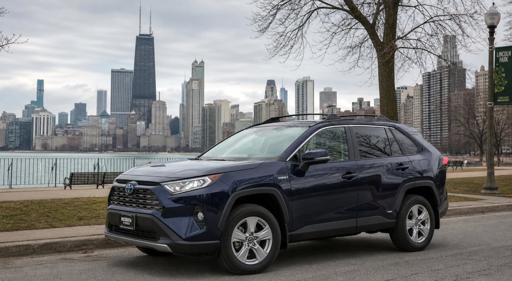 Toyota RAV4 Hybrid parked on a Lincoln Park street with the Chicago skyline in the background