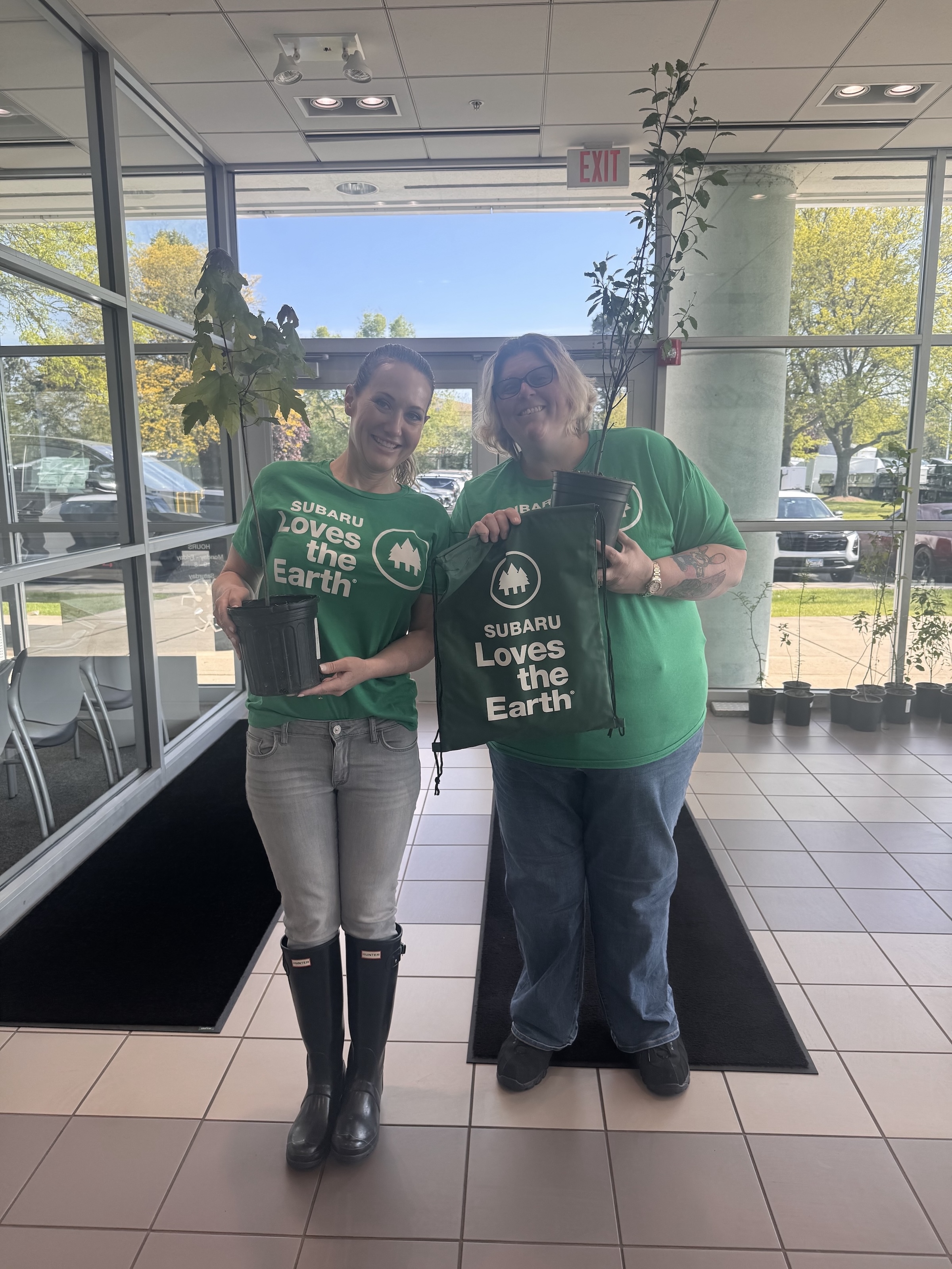 Subaru McHenry team members holding trees during Subaru Loves the Earth