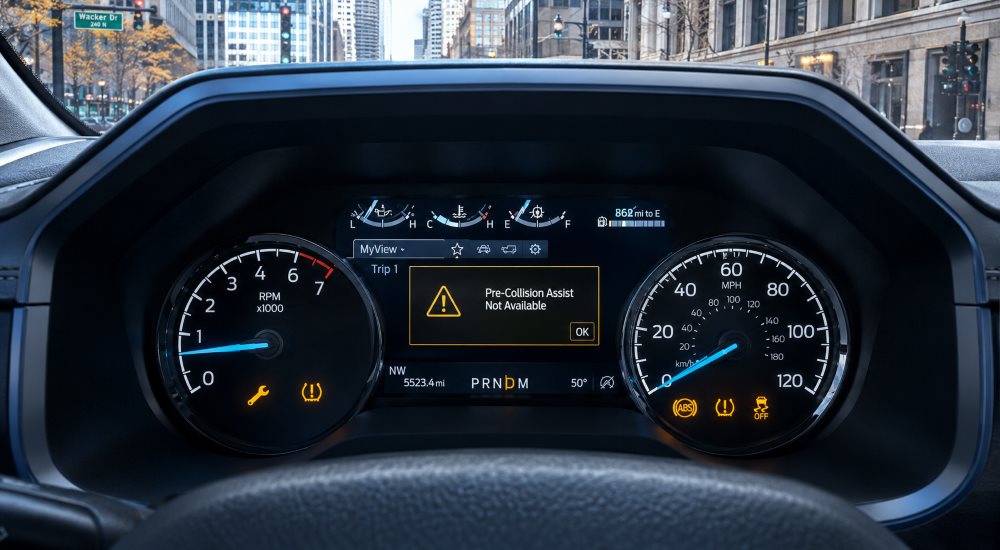 Ford F-150 instrument cluster showing dashboard warning lights including wrench symbol and tire pressure indicator