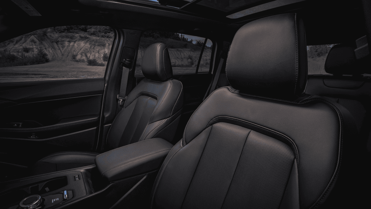 2026 Jeep Cherokee in Margate FL showing black perforated leather front and rear seats with panoramic sunroof and desert landscape visible through windows