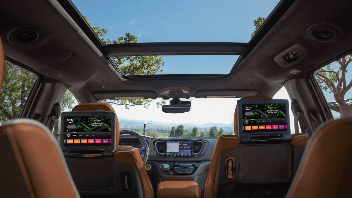 2026 Chrysler Pacifica interior in Margate FL featuring dual Amazon Fire TV rear seat entertainment screens, panoramic sunroof, and tan leather second-row captain's chairs