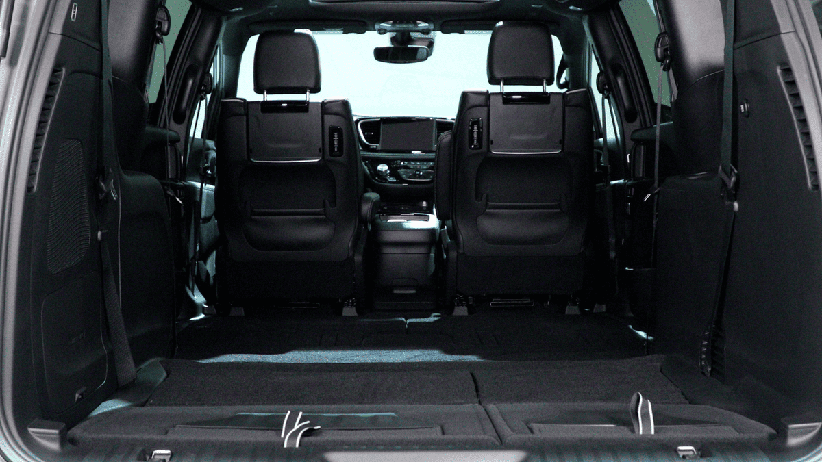 2026 Chrysler Pacifica in Margate FL showing wide-open rear cargo area with third-row seats folded flat, revealing spacious black interior load floor