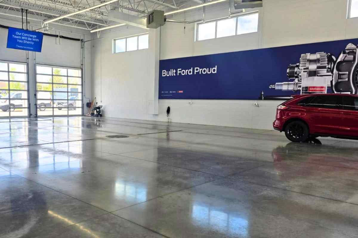 Interior of Boucher Ford Kenosha service department featuring concierge service lanes, Built Ford Proud branding, and a bright, clean Ford service bay.