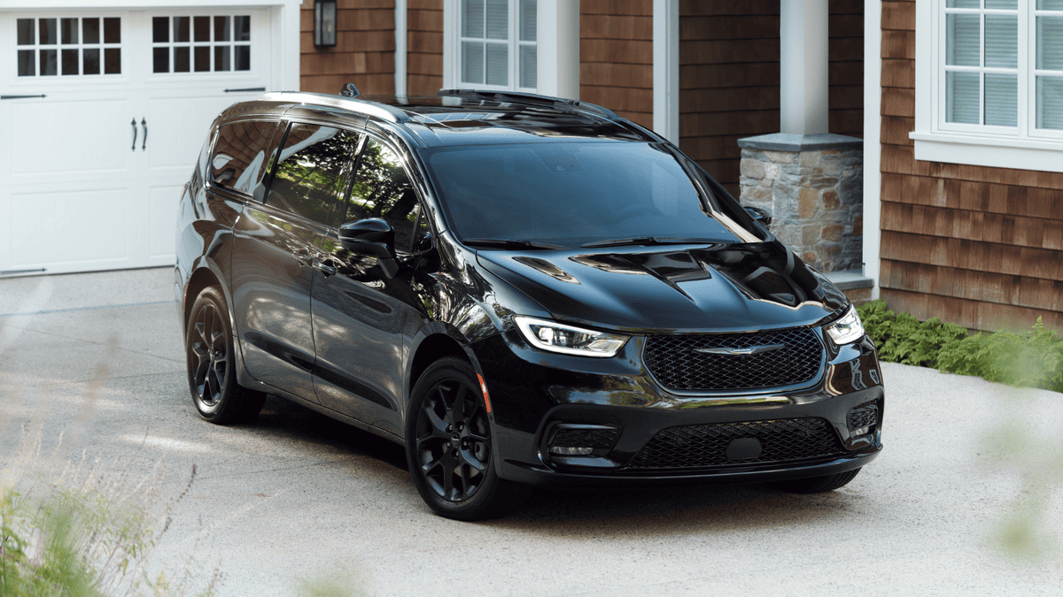 2026 Chrysler Pacifica in Margate FL in all-black with blacked-out grille, black alloy wheels, and panoramic roof parked in a suburban home driveway — the family minivan built for everyday life