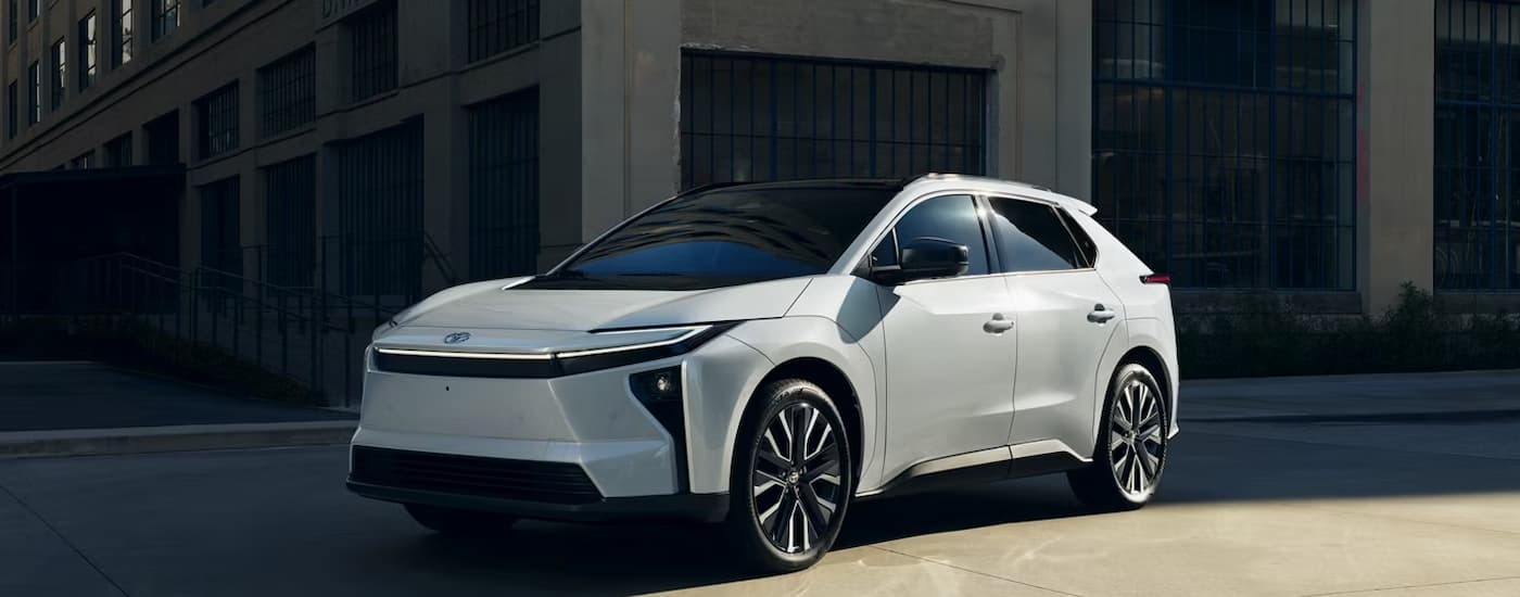 White 2026 Toyota bZ driving around a bend.