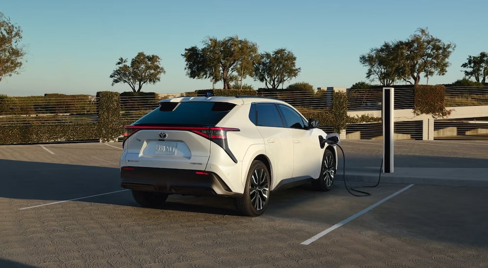 Rear of a white 2026 Toyota bZ parked on a driveway.