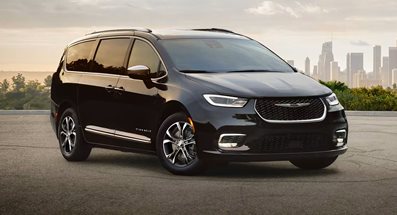 Chrysler Pacifica parked in front of a city skyline