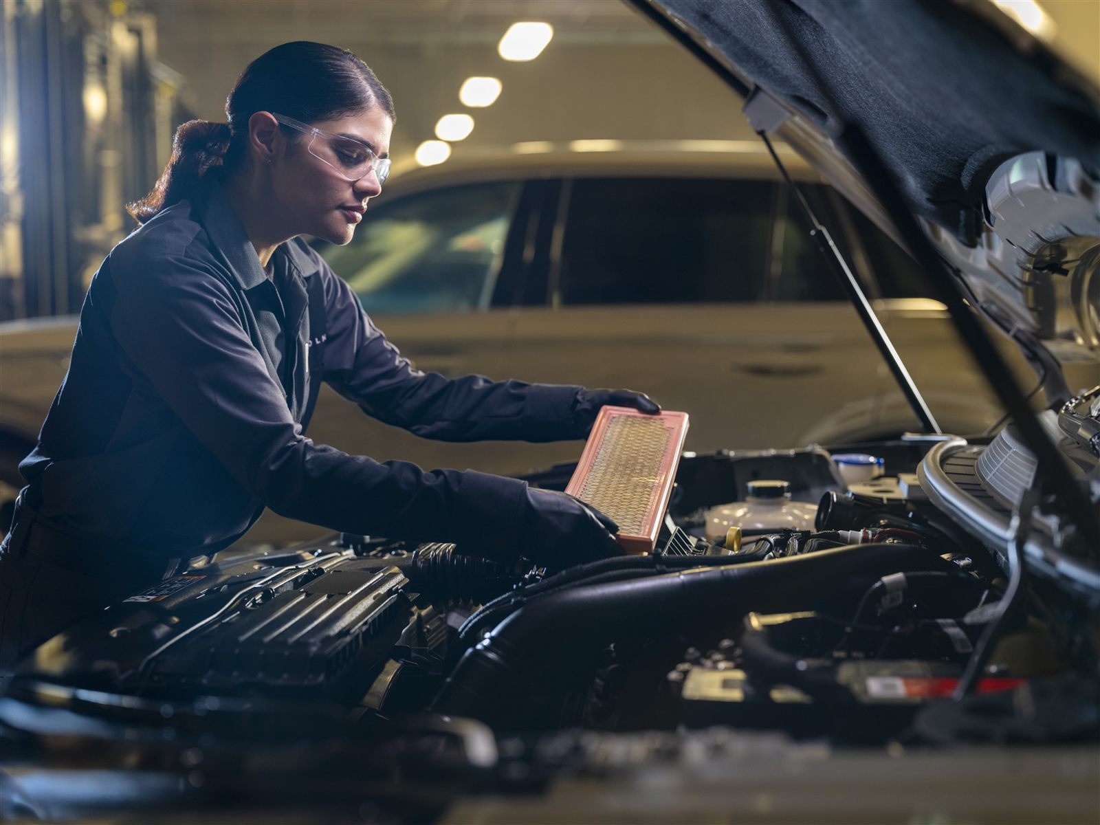 Technician inspecting air filter during multi-point inspection