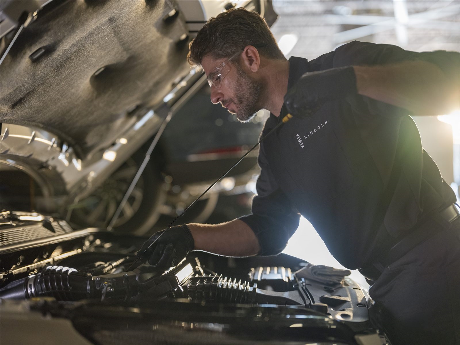Technician performing The Works complete vehicle checkup at Murgado Lincoln of Chicago