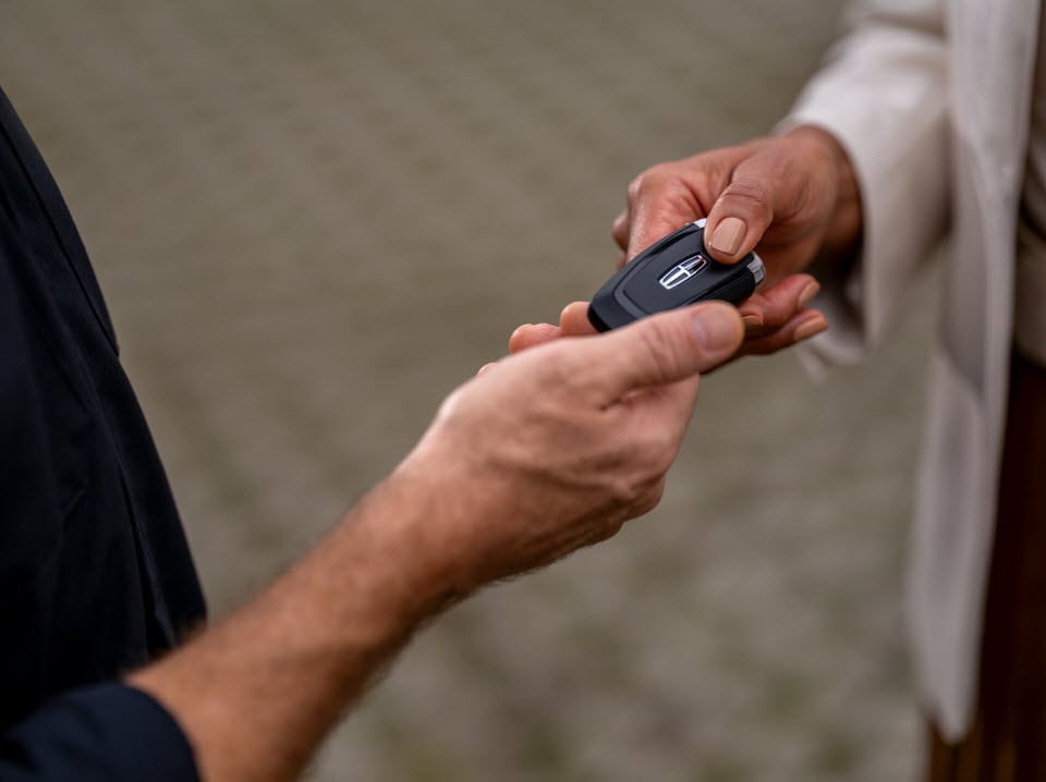 Lincoln owner in residential driveway scheduling pickup and delivery service