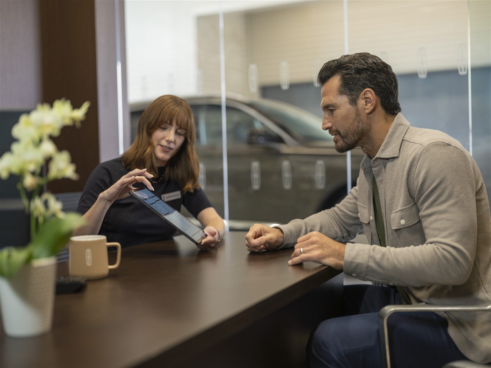 Service advisor reviewing savings options with customer at Murgado Lincoln of Chicago